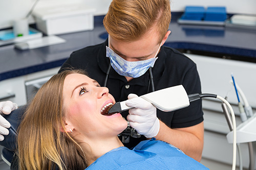 A dental hygienist assisting a patient during a dental procedure.